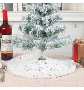Close-up of white plush Christmas tree skirt with gold foil star patterns and soft texture
