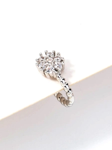 Detailed macro view of a silver stainless steel nose stud with star-shaped cubic zirconia