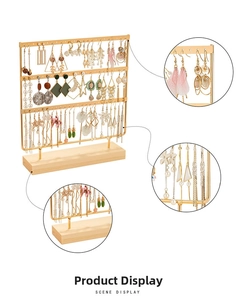 Detailed close-up of 3-tier gold iron earring organizer with solid wood base
