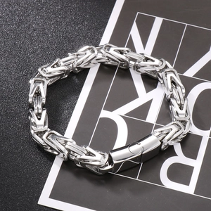 Macro detail of silver Byzantine chain bracelet with heavy industrial metal texture