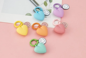 Detailed view of colorful heart-shaped keychains with matching cartoon smiley face charms