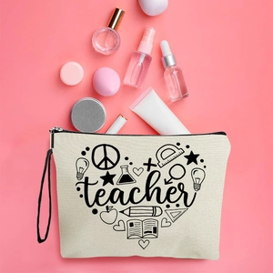 Canvas teacher makeup bag with heart-shaped stationery print and black zipper on pink background