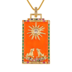 Golden tarot moon pendant necklace with sun motif, orange enamel, and colorful crystals