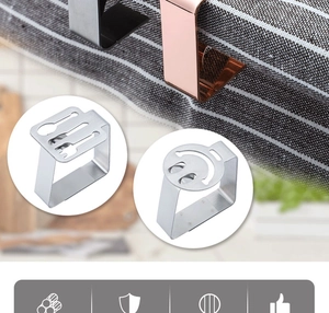 Detail of silver and rose gold leaf-shaped tablecloth clips with cutlery and face patterns