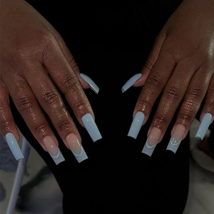 Blue glossy press-on nails with solid color and French design shown on hands