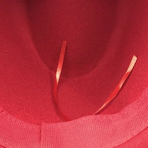Close-up of red wool fedora interior featuring an adjustable inner ribbon for custom sizing