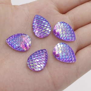 Macro detail of purple teardrop resin scales with iridescent AB plating on a hand