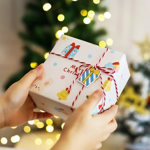 Christmas gift box with cartoon rabbit patterns and silk ribbon in festive holiday setting