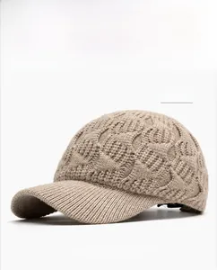 Detail of khaki cable knit texture and ribbed brim on warm winter baseball cap