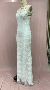 Detail view of white lace maxi dress with intricate 3D floral embroidery and mesh fabric
