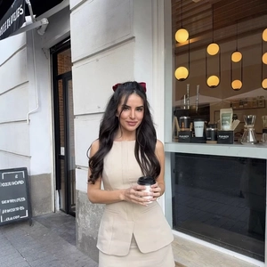 Elegant beige sleeveless two-piece skirt set for women with matching belt and slim waist design