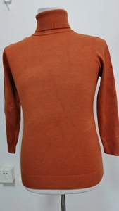 Detailed close-up showing the fine knit texture of this burnt orange slim-fit turtleneck