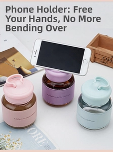 Detail of the grooved lid on the chubby glass cup serving as a mobile phone holder