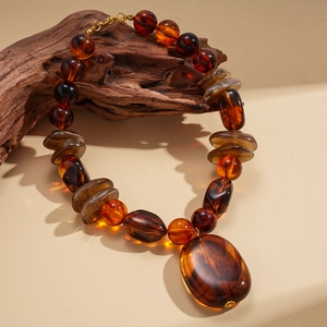 Bohemian acrylic chunky necklace with irregular geometric amber beads on rustic wood