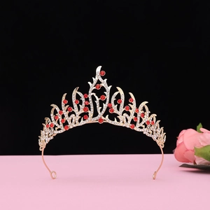 Detailed view of Baroque vintage crown with red crystals on gold metal base
