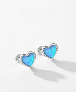 Close-up of heart-shaped opal earrings in S925 sterling silver with zircon accents