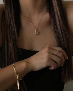 Detail of 18k gold plated lock pendant necklace and matching jewelry set on model