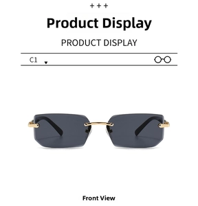 Front view of rimless rectangular sunglasses with gold metal bridge and dark grey lenses