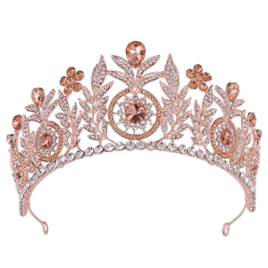 Elegant rose gold tiara with champagne crystals and floral rhinestone design on white background