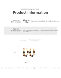 Detail view of tiger eye and pearl hoop earrings with copper and silver needles