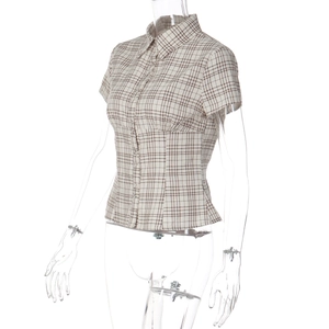 Detail of checkered short sleeve shirt featuring classic lapel and single-breasted buttons