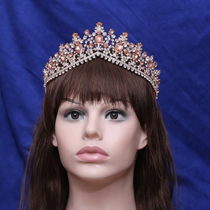 Close-up of a bridal crown with rhinestones and champagne gems on a navy background