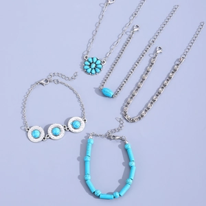 Five-piece vintage Bohemian turquoise bracelet set in silver metal on purple background