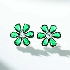 Macro shot of S925 silver flower earrings with emerald green pear-cut zircon petals