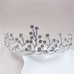 Close-up of a silver rhinestone crown headband with sparkling crystals for girls