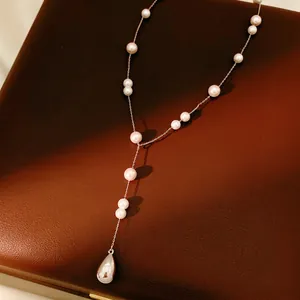 Elegant Y-shaped necklace featuring white pearls and a polished metallic teardrop pendant