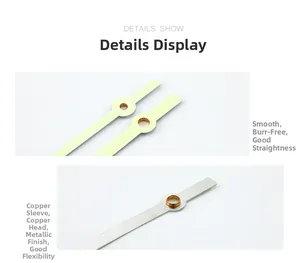 Close-up of luminous clock hands with brass bushings and smooth metallic finish