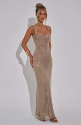 Close-up of sparkling champagne gold sequins on the fitted mermaid evening dress