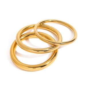 Polished 18k gold plated titanium steel bangles set in high-shine mirror finish