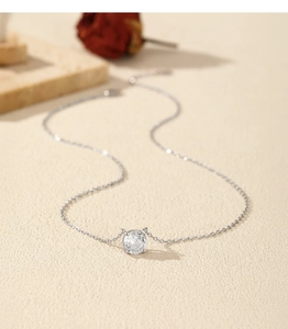 Macro detail of a sparkling rose-cut round gem pendant on a fine S925 silver chain