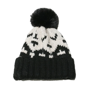 Winter knit beanie with black pom-pom and classic black-and-white geometric wave pattern