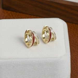 Elegant gold hoop earrings with micro-set zircons and a vibrant red enamel stripe
