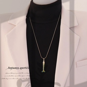 Detailed close-up of a golden koi fish pendant necklace with colorful enamel detailing