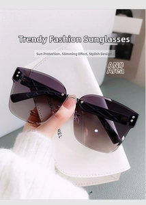 Detail of rimless gradient sunglasses featuring ornate carved temples and a white case