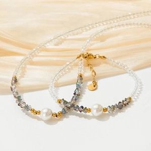 Detail of faceted colorful crystals and white pearls on a gold-plated stainless chain