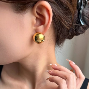 Polished golden spherical earrings for women with a minimalist vintage metallic design