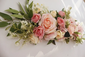 Detail of pink and champagne artificial rose flower row for wedding chair and table decor