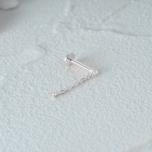 Macro detail of S925 sterling silver star stud with diamond chain and flat screw back