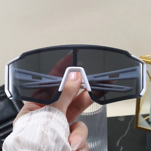 Detailed close-up of white wide-frame cycling sunglasses with grey one-piece shield lens