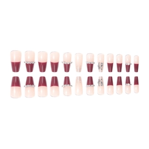 French tip press-on nails in burgundy and nude pink with rhinestones and long coffin shape