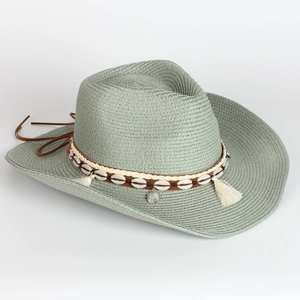 Detail of grey-green straw cowboy hat featuring shells, white tassels and ethnic trim