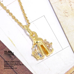 Macro shot of 18k gold plated beetle pendant with shiny zircon wing details