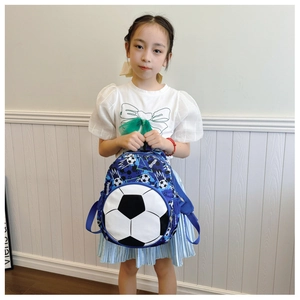 Kids football backpack with blue camouflage print and 3D ball design on model