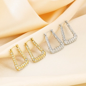 U-shaped 18K gold and silver plated earrings with diamonds on silk background