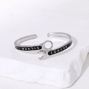 Silver wrench-shaped stainless steel cuff bracelet with black enamel and forever engraving