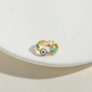 Adjustable gold open ring featuring a blue evil eye design and green enamel accents